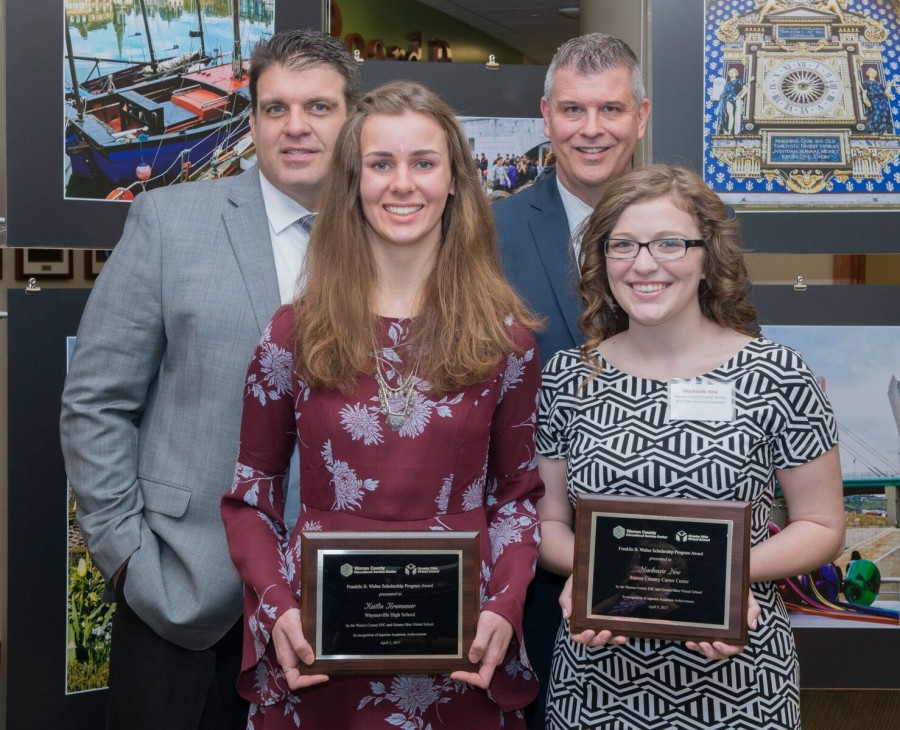 image of people of which some are holding plaques